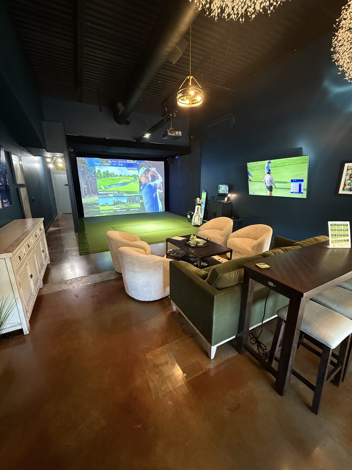 Swing Eazy 365 lounge with golf simulator screen and seating